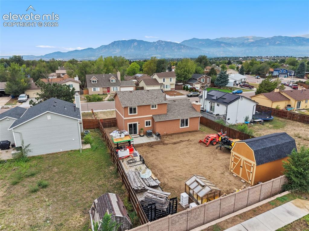 Image 4 of 28: The backyard features a massive storage shed and greenhouse