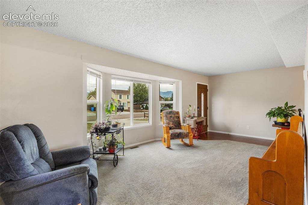 Image 5 of 28: Tons of natural light from the bay window in the living room