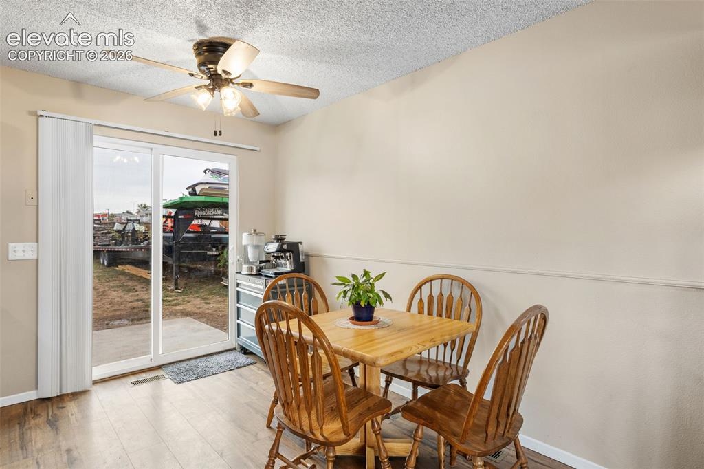 Image 7 of 28: The kitchen and dining area walk-out to the expansive backyard