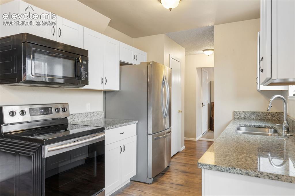Image 8 of 28: Kitchen updates include newer cabinets, appliances, and granite countertops