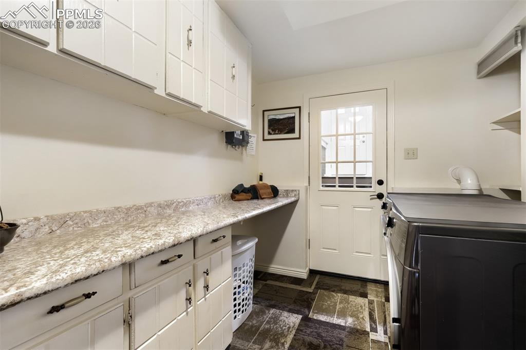 Image 20 of 42: Basement laundry and fold space
