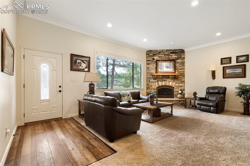 Image 6 of 42: Main Home Living Room with stone fireplace