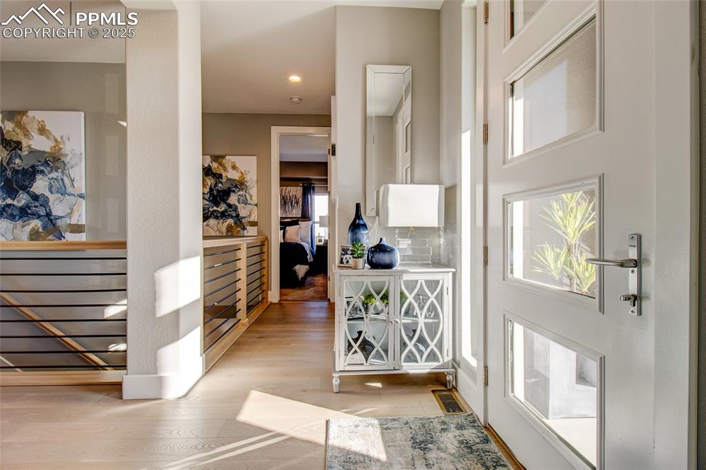 Image 13 of 30: Foyer entrance with light wood-style floors and recessed lighting