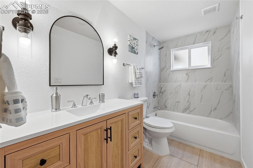 Image 18 of 26: Full bath featuring vanity and shower / washtub combination