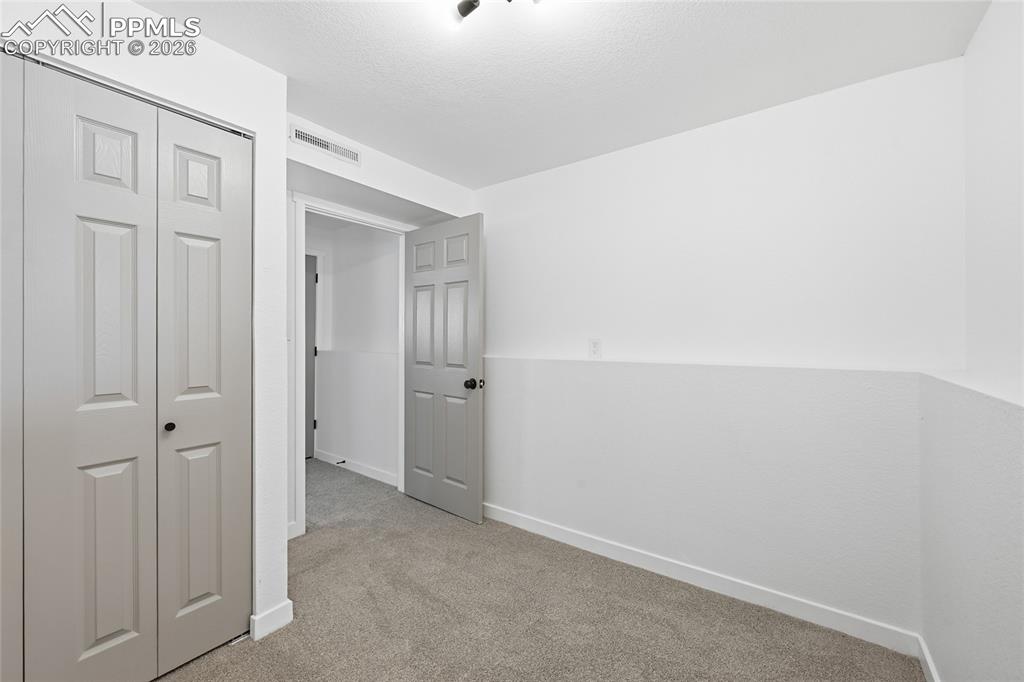 Image 19 of 26: Unfurnished bedroom featuring a closet and light colored carpet