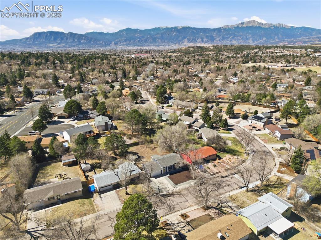 Image 23 of 26: Aerial view of residential area featuring a mountain backdrop