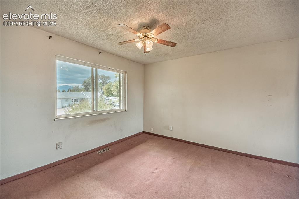 Image 21 of 50: Window with exterior scenery, overhead ceiling fan with light fixture, and 