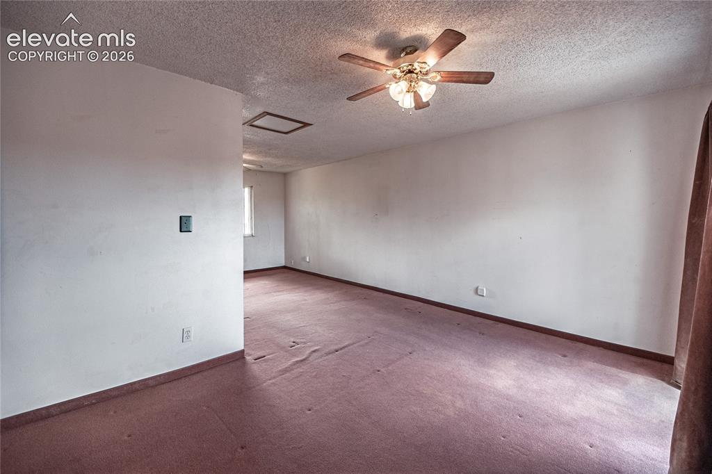 Image 25 of 50: Spacious open room with ceiling fan and recessed lighting, wood-finish floo