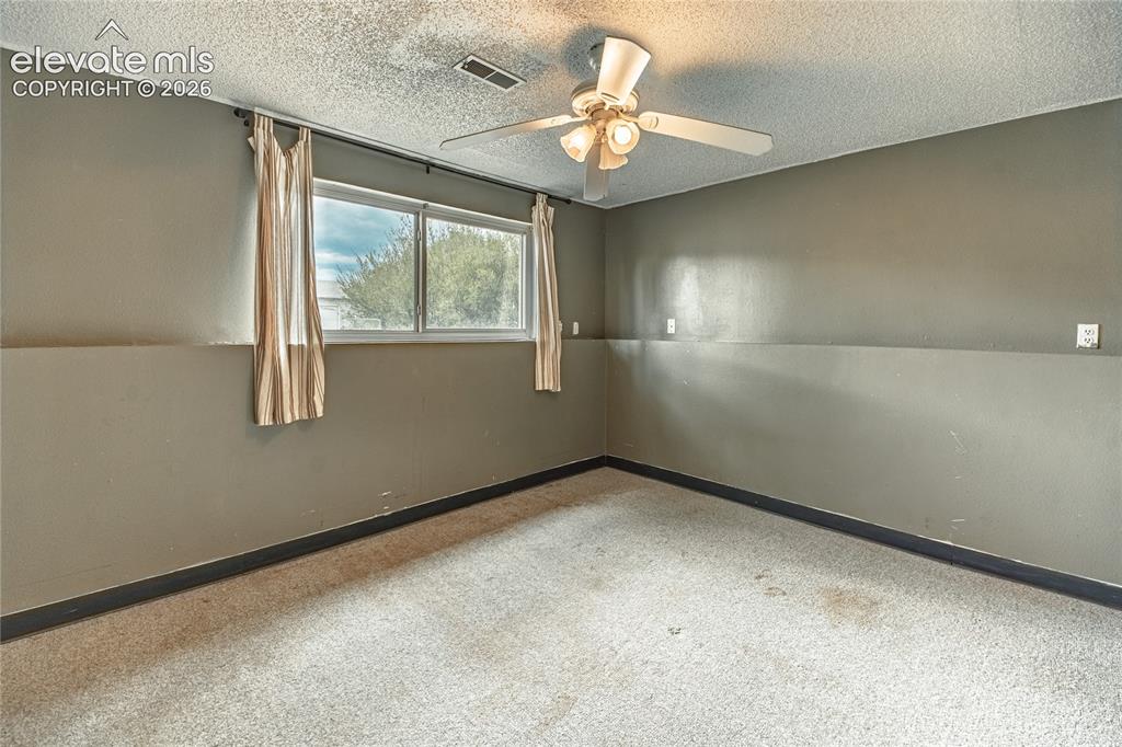 Image 36 of 50: Dual pane window, ceiling fan with integrated lighting, textured ceiling, w