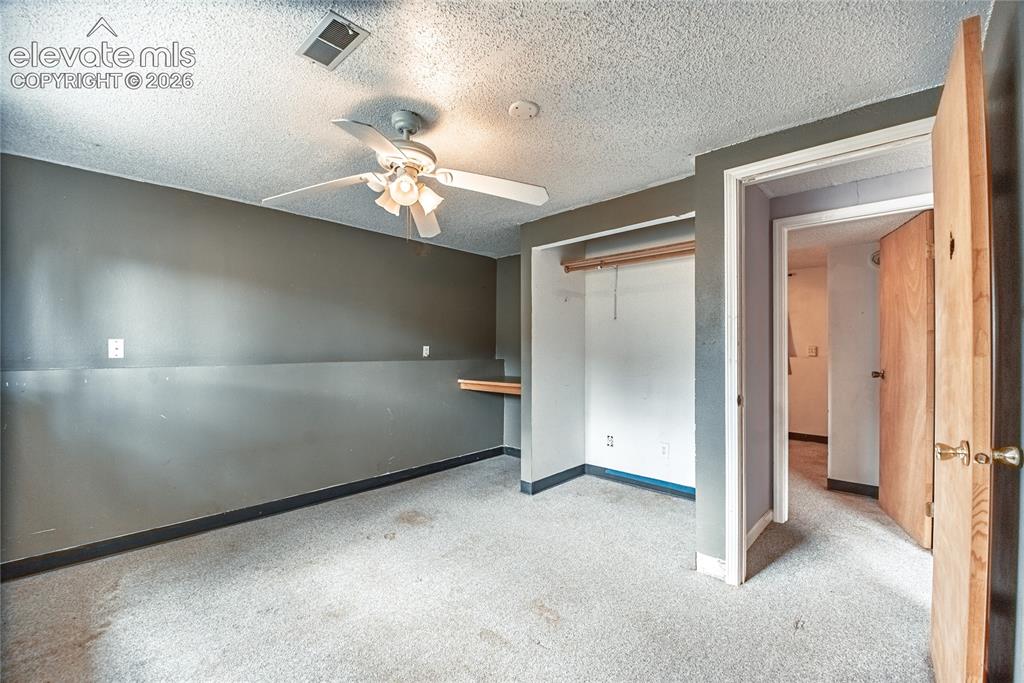 Image 37 of 50: Room featuring a ceiling fan, a built-in closet with hanging rod, and a woo