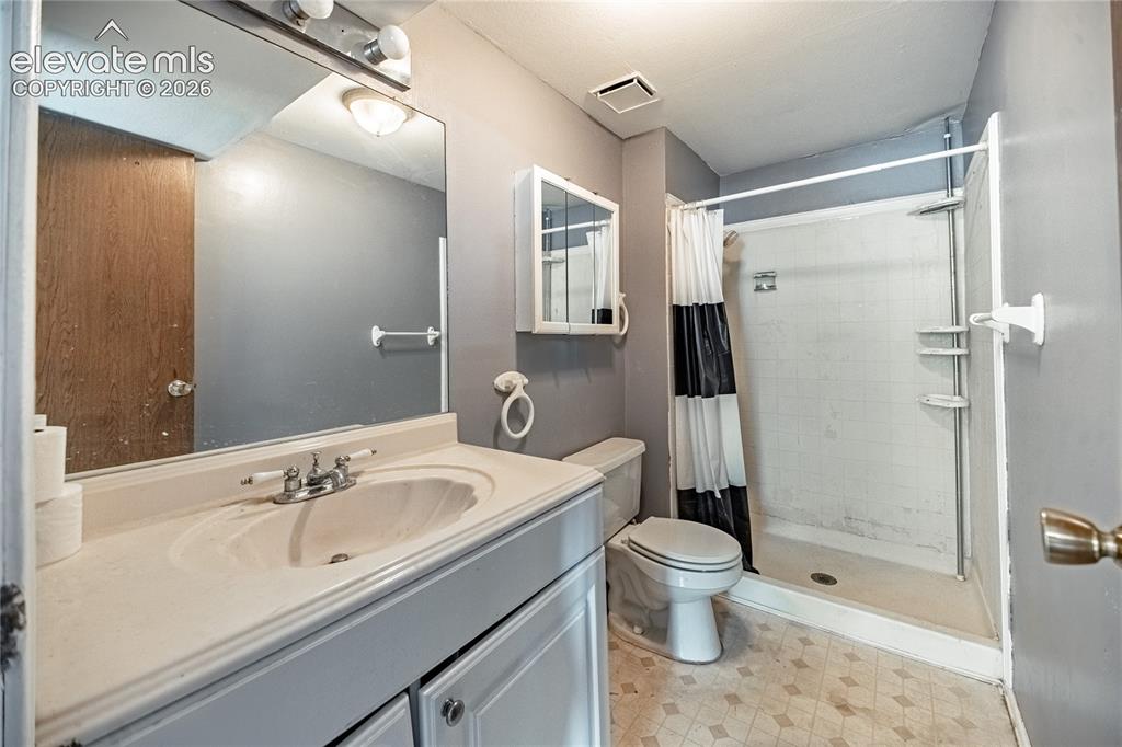 Image 42 of 50: Vanity with integrated sink, wall-mounted mirror, medicine cabinet, and sho