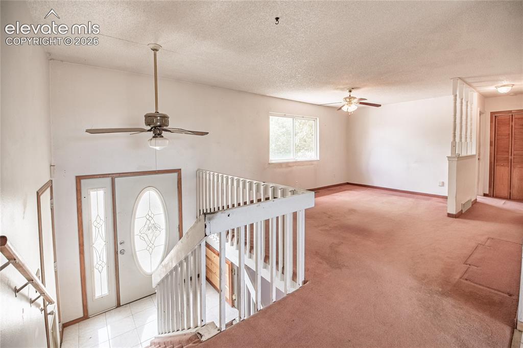 Image 5 of 50: Entryway with decorative glass door and transom, complemented by a ceiling
