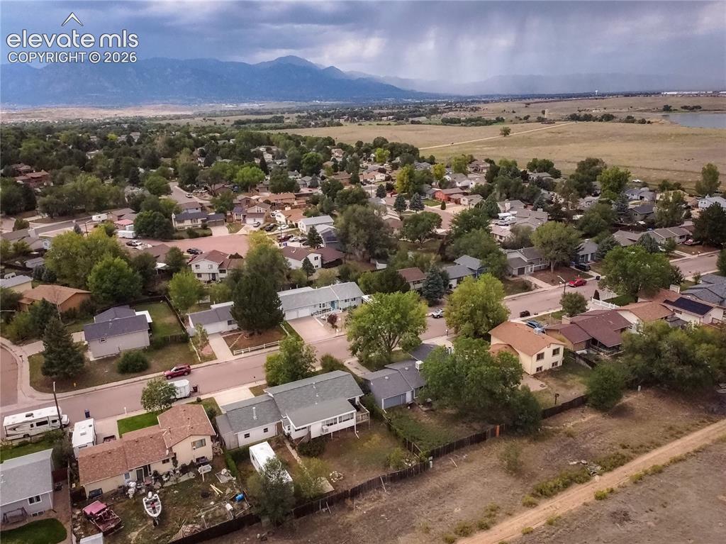 Image 50 of 50: Residential neighborhood with mature trees and mountain backdrop