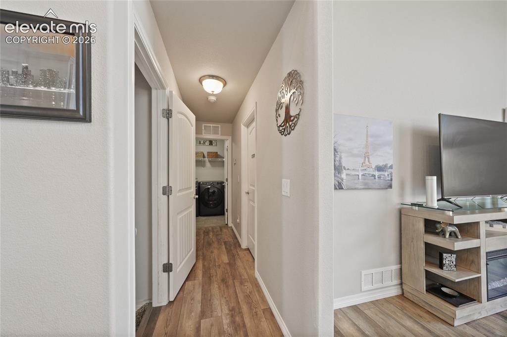 Image 16 of 42: Hallway To Primary Bedroom On Main Level