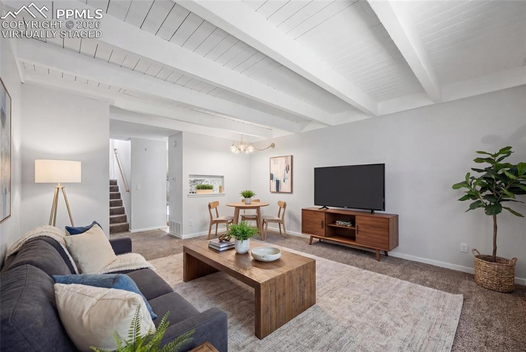 Image 13 of 44: virtually staged Living room with dining area for a table.