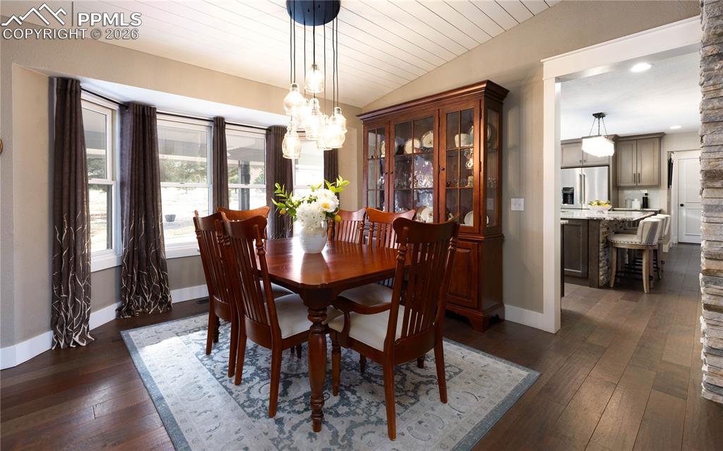 Image 12 of 42: Dining area with lovely light fixture.