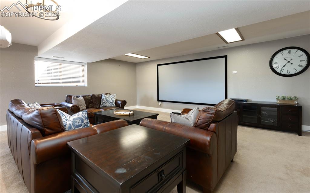 Image 21 of 42: Basement theater area with included screen and projector