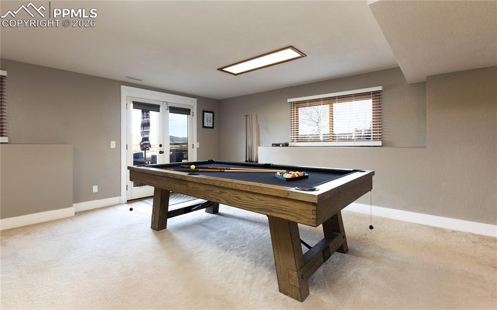 Image 22 of 42: Large game room walks out to backyard