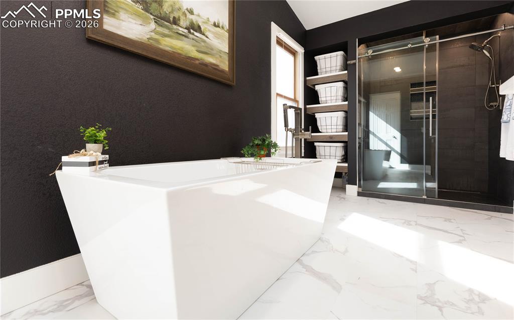 Image 27 of 42: Tub and large shower 