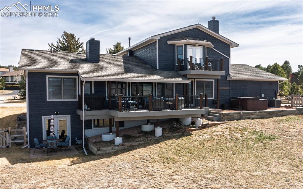 Image 39 of 42: 2 decks, hot tub and walkout basement