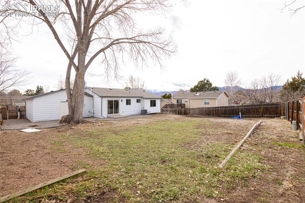 Image 28 of 33: View of yard featuring a fenced backyard and a patio area