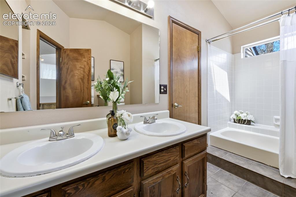 Image 13 of 45: Upper full bath with double vanity