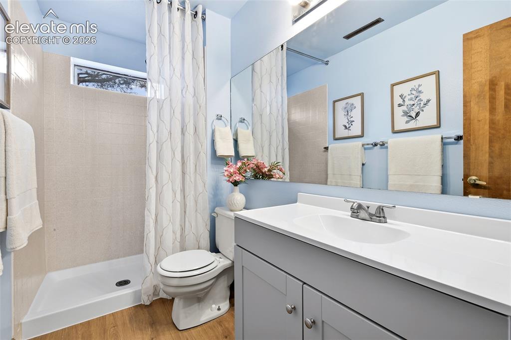 Image 20 of 45: Lower level bathroom recently updated, has transom window!