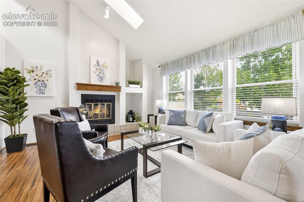 Image 3 of 45: Vaulted Living room with skylights that let the light in!