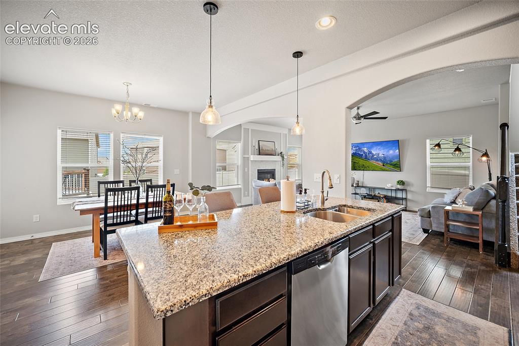 Image 13 of 49: Kitchen island featuring a double-basin undermount sink with a gooseneck fa