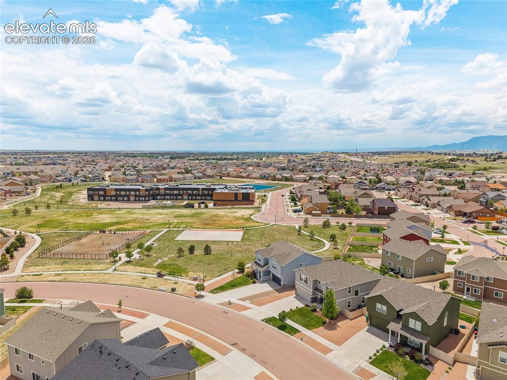 Image 41 of 49: Aerial perspective of a residential neighborhood featuring detached homes w