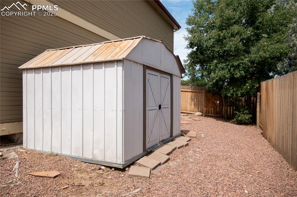 Image 38 of 41: metal storage building located on the east side yard