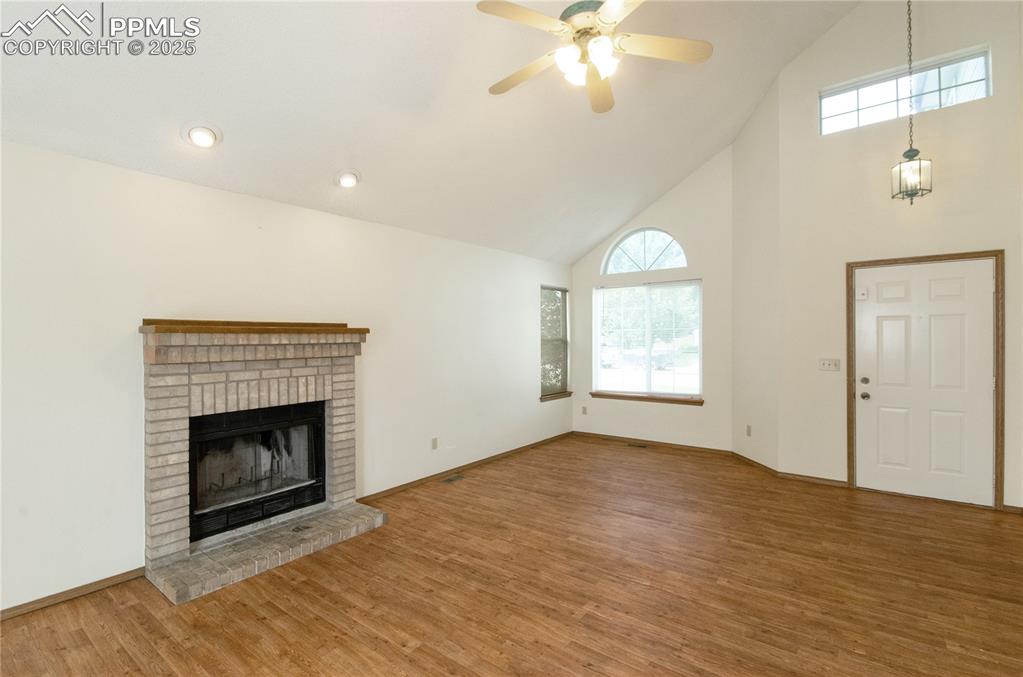 Image 4 of 41: Entry and Living room with wood burning fireplace