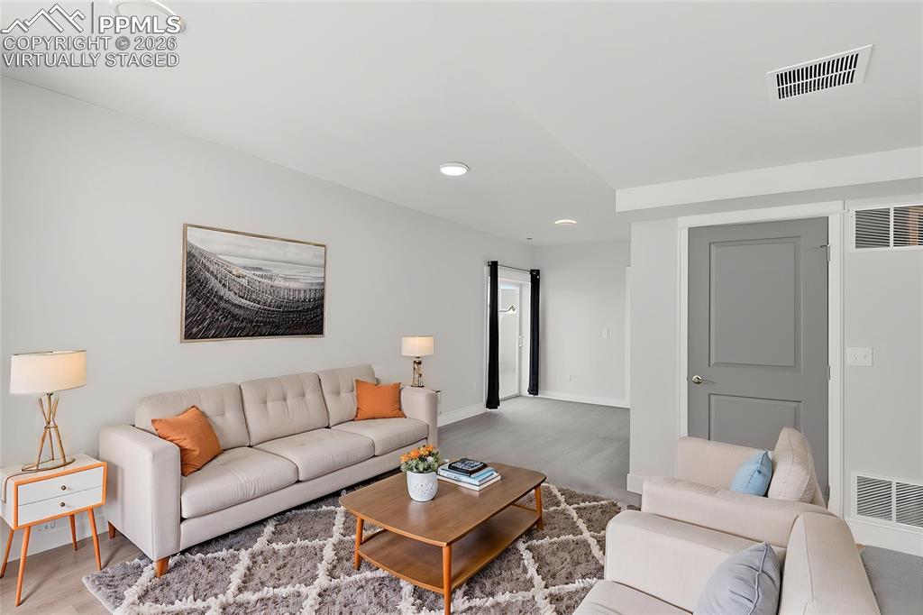 Image 19 of 28: Virtually staged basement family room