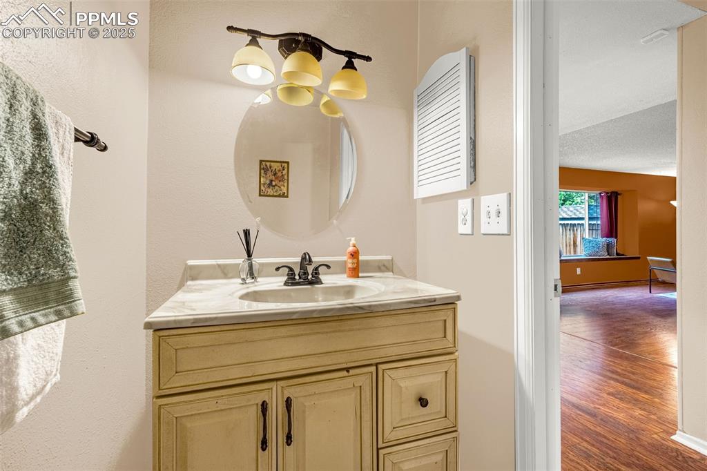 Image 13 of 40: Bathroom featuring vanity and wood finished floors