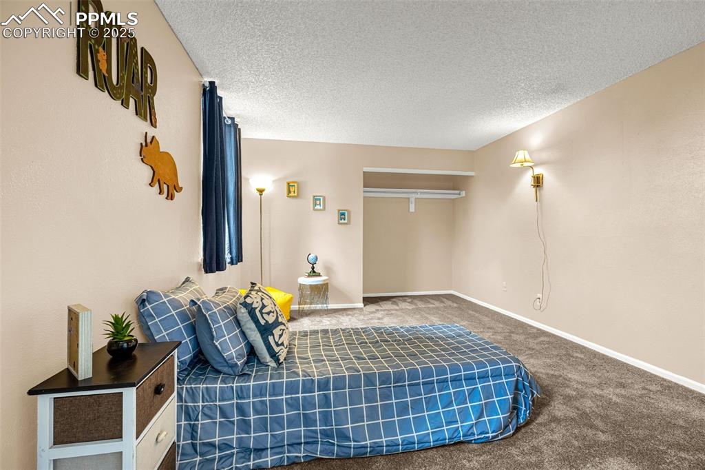Image 21 of 40: Carpeted bedroom with baseboards
