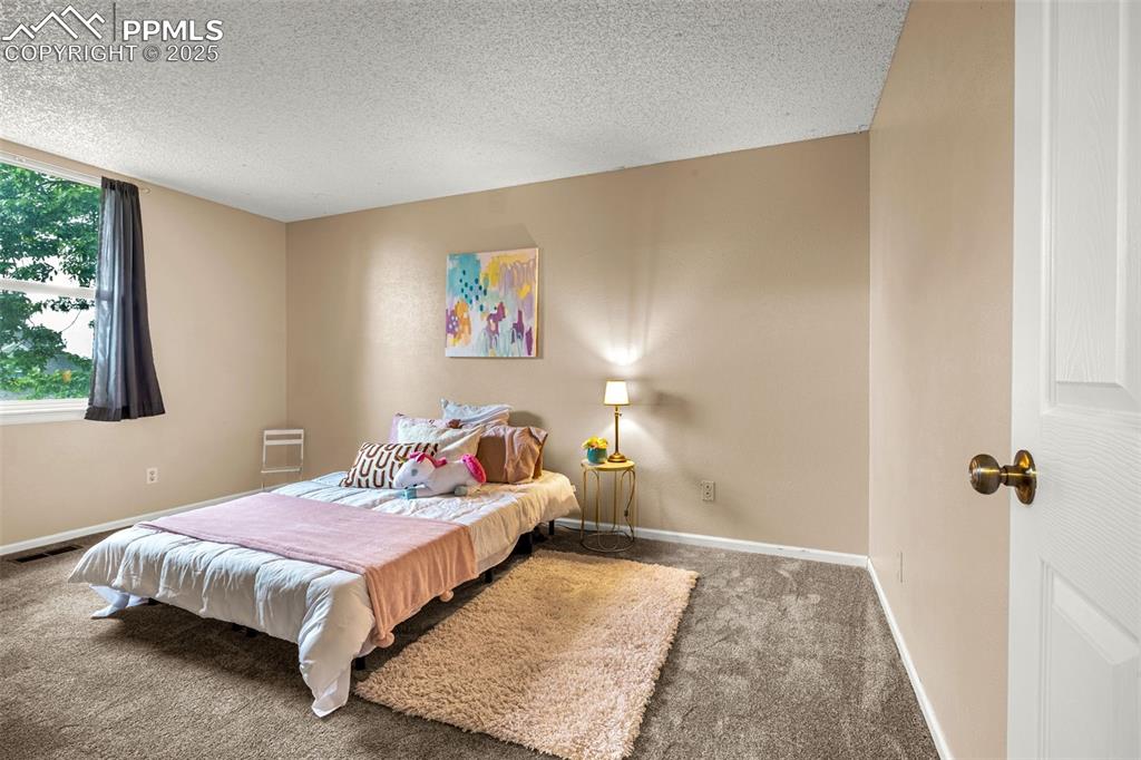 Image 23 of 40: Bedroom with carpet flooring and baseboards