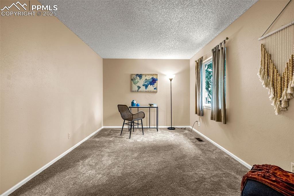 Image 24 of 40: Carpeted home office  and baseboards