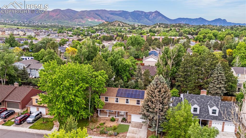 Image 35 of 40: Aerial view of residential area with a mountainous background
