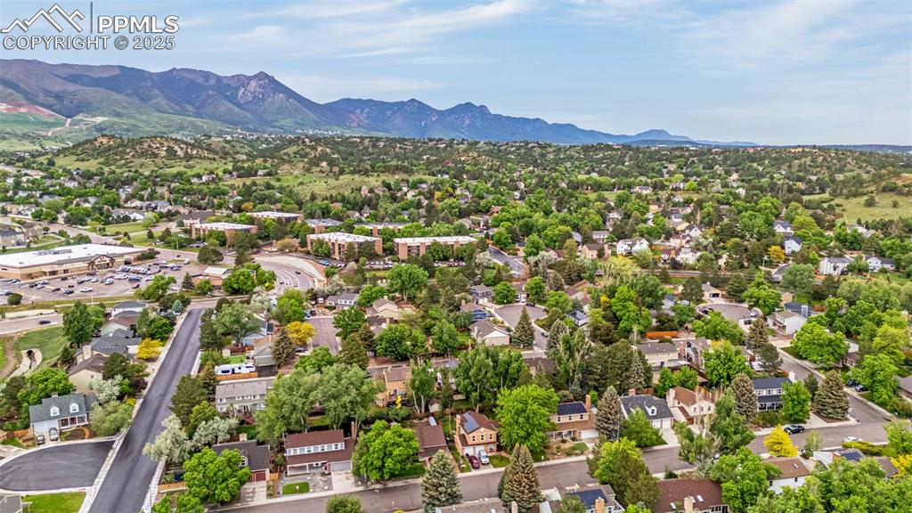 Image 40 of 40: Aerial view of residential area with a mountain backdrop