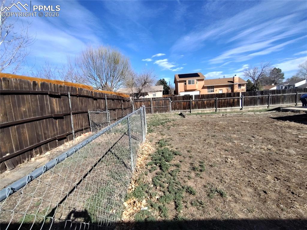 Image 43 of 45: Dog run in backyard