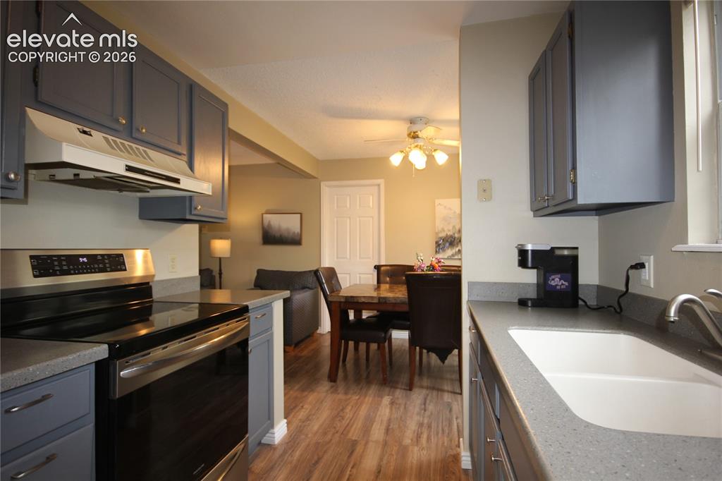 Image 15 of 33: Stainless Steel Stove, Hardware and updated cabinetry with fresh paint.