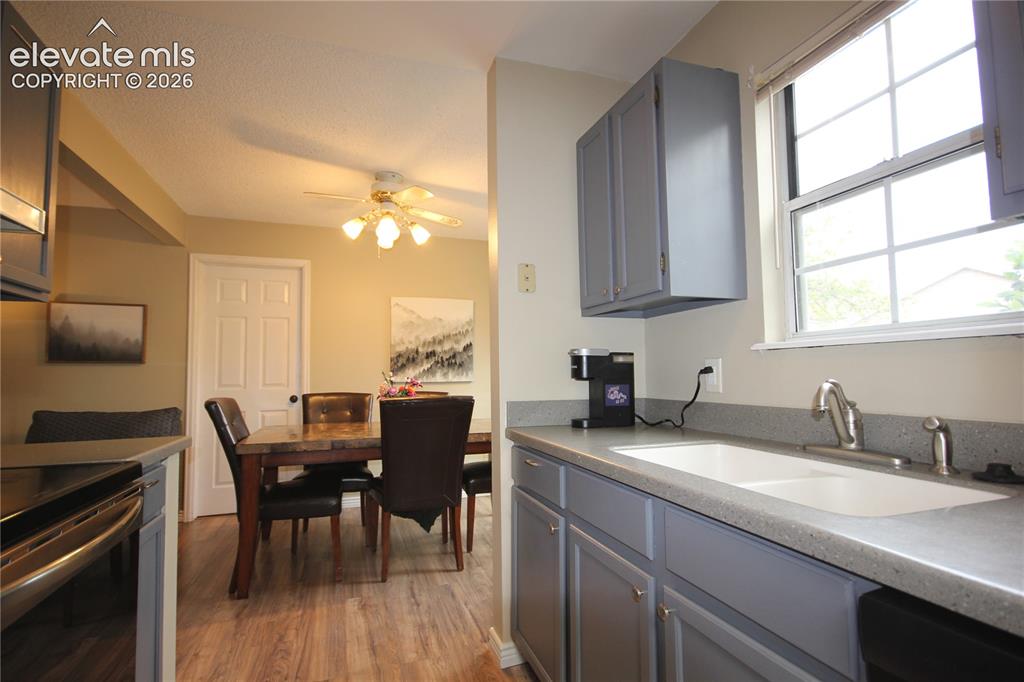 Image 16 of 33: Undermount sink with a window above looking out to the back of home.