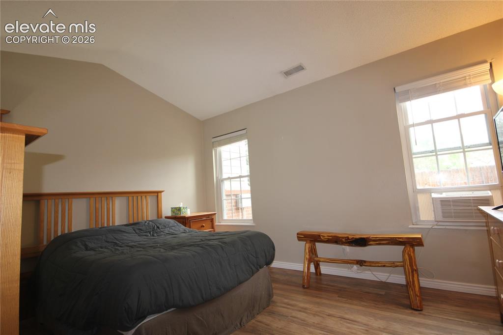 Image 19 of 33: Primary Bedroom looks out to the north side of home with two windows bringi