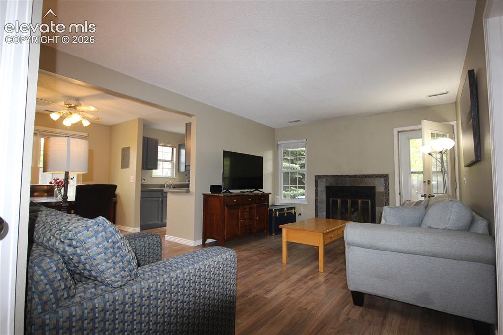 Image 4 of 33: Spacious Living area with luxury vinyl floors, fireplace and walk out to ba
