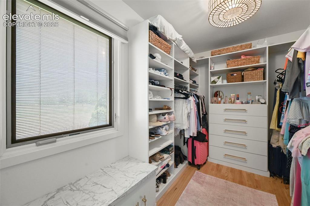 Image 24 of 50: Walk in closet with built in shelving