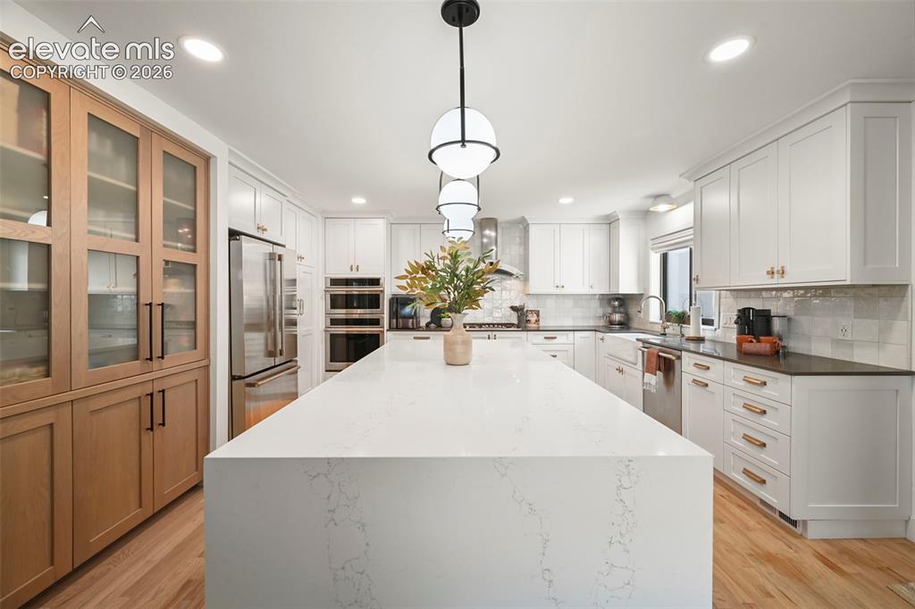 Image 8 of 50: Gorgeous waterfall finish on the island