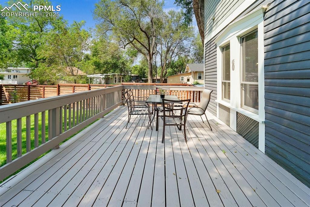 Image 25 of 28: Wooden terrace featuring outdoor dining area