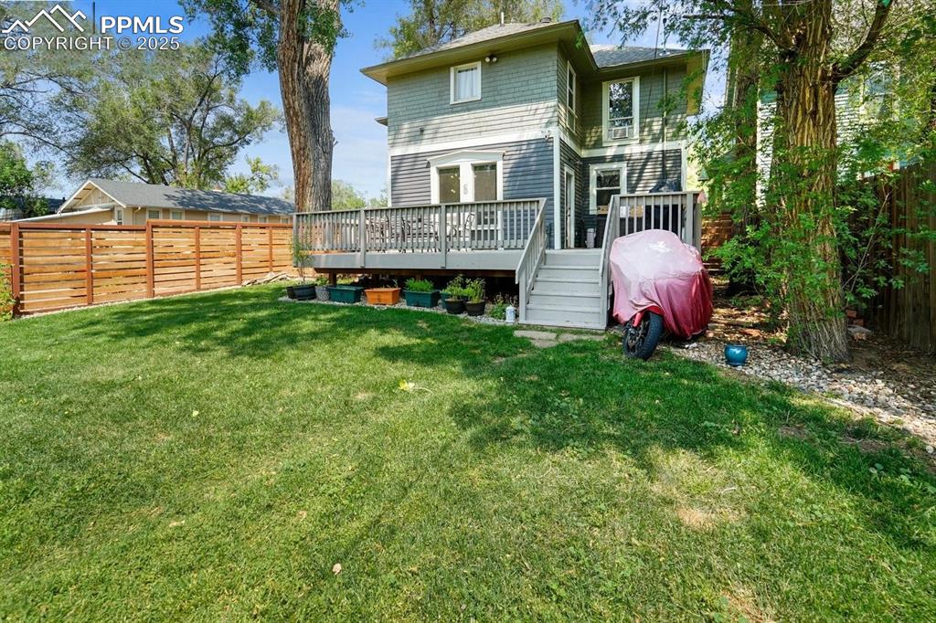 Image 27 of 28: Back of property featuring a deck