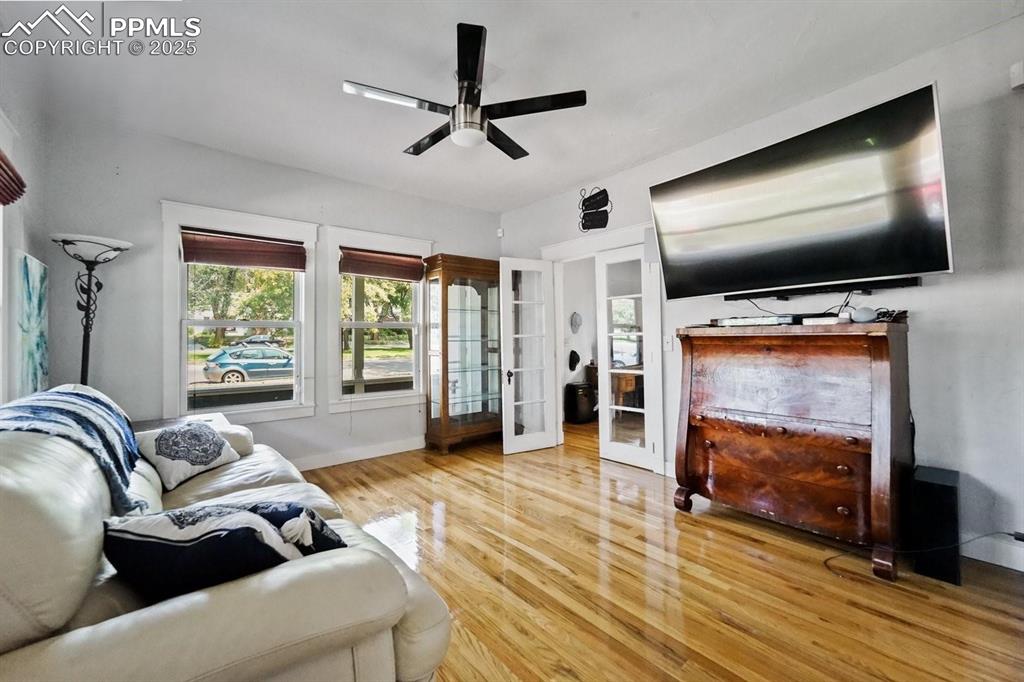 Image 4 of 28: Living room featuring french doors, wood finished floors, and ceiling fan