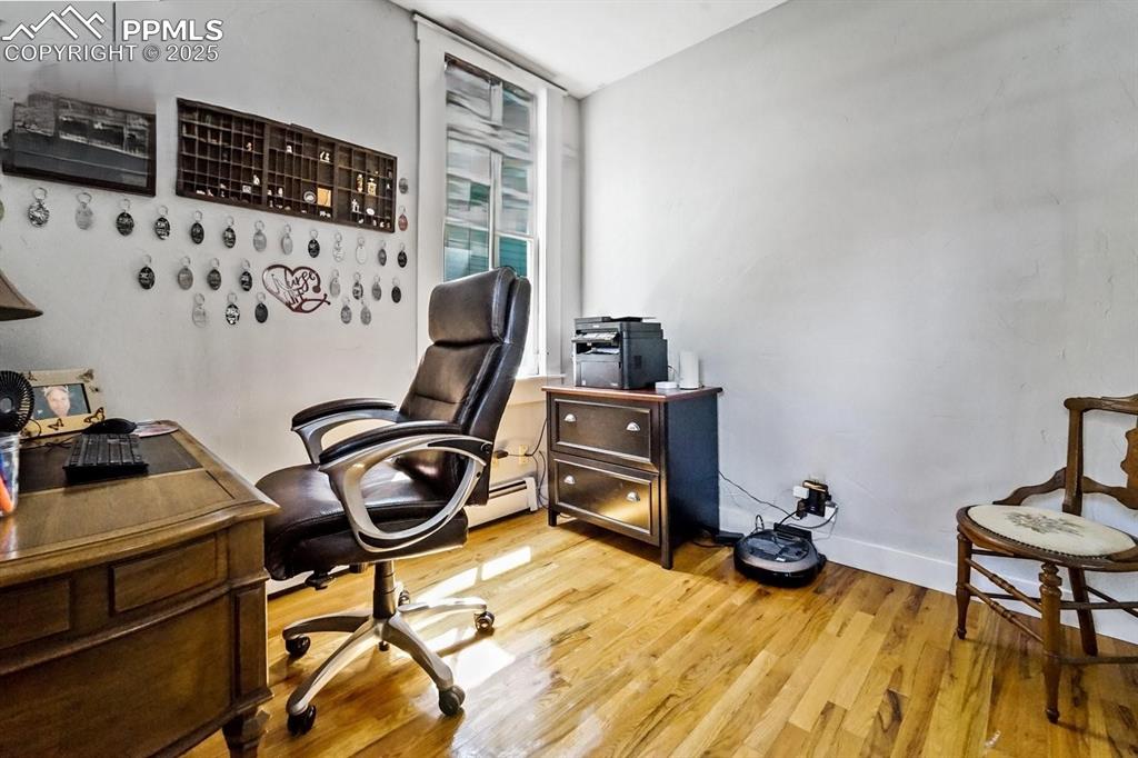 Image 7 of 28: Office featuring baseboards and light wood-style flooring